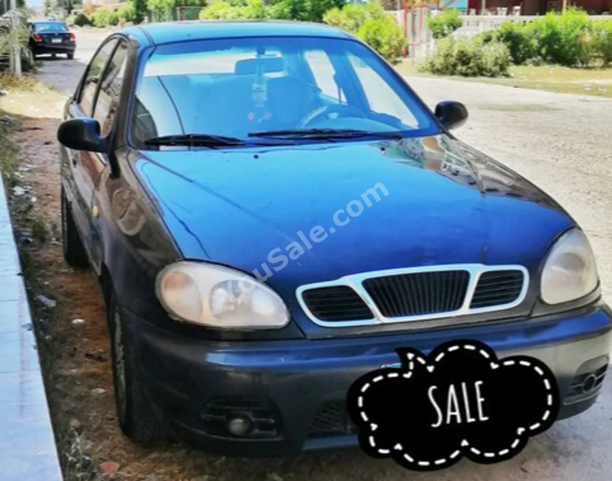 دايو لانوس 2001 سيدان عادي 4 سلندر 248,000 كم دفع أمامي أسود بنزين